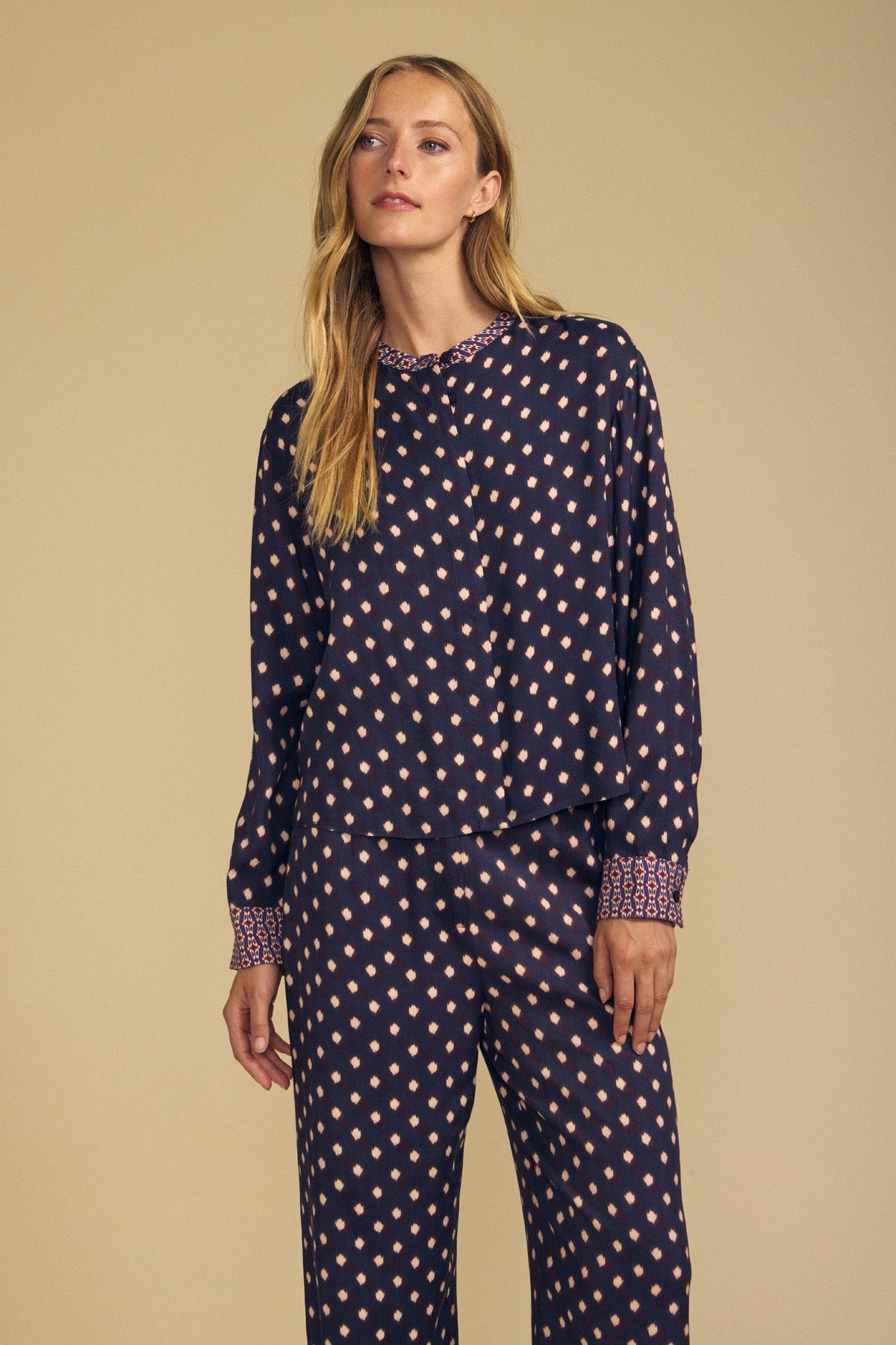 The Velvet by Graham & Spencer ERIKA PRINTED BLOUSE is a long-sleeved navy viscose top with a pink diamond border print, a button-front collar, and matching cuffs.-46488190091457