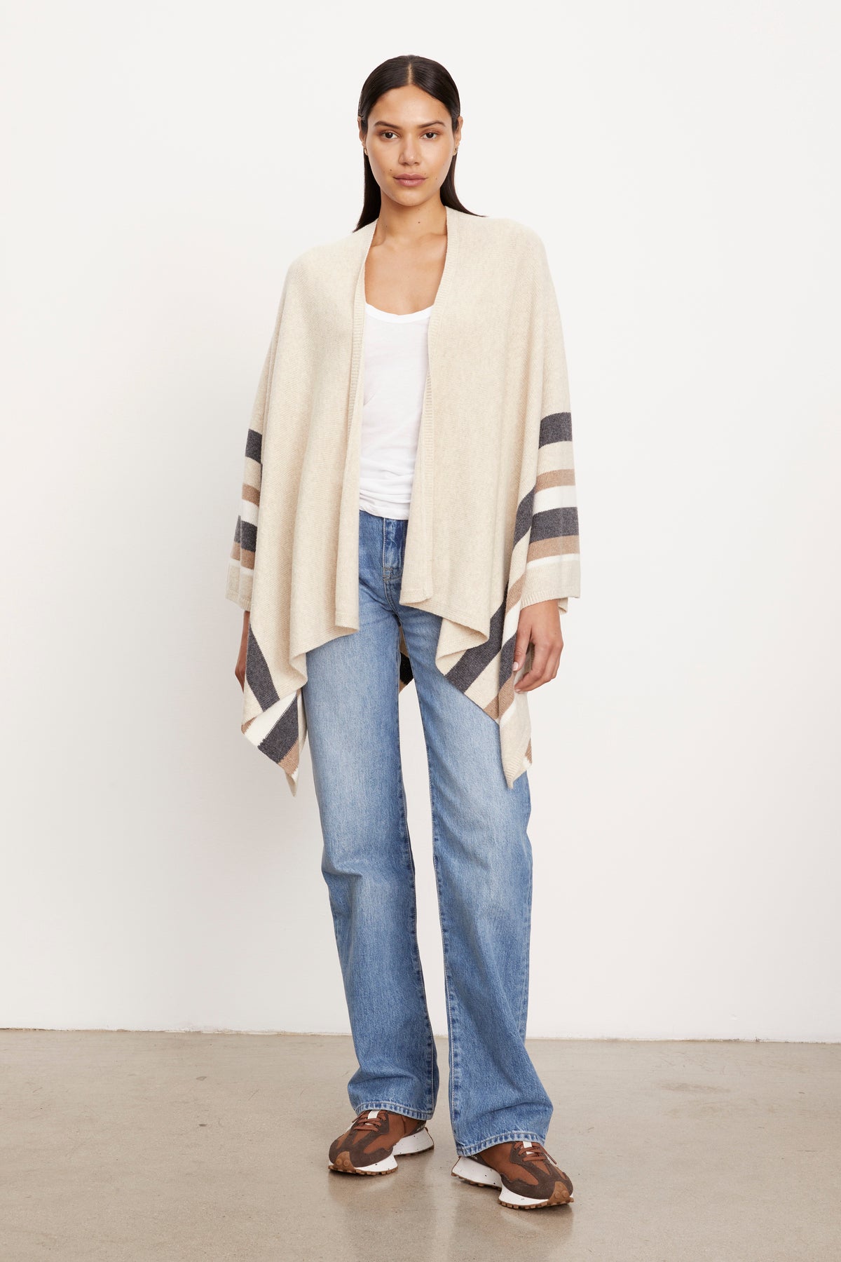The model is wearing jeans and a Velvet by Graham & Spencer HARPER OPEN FRONT PONCHO.-26897792991425