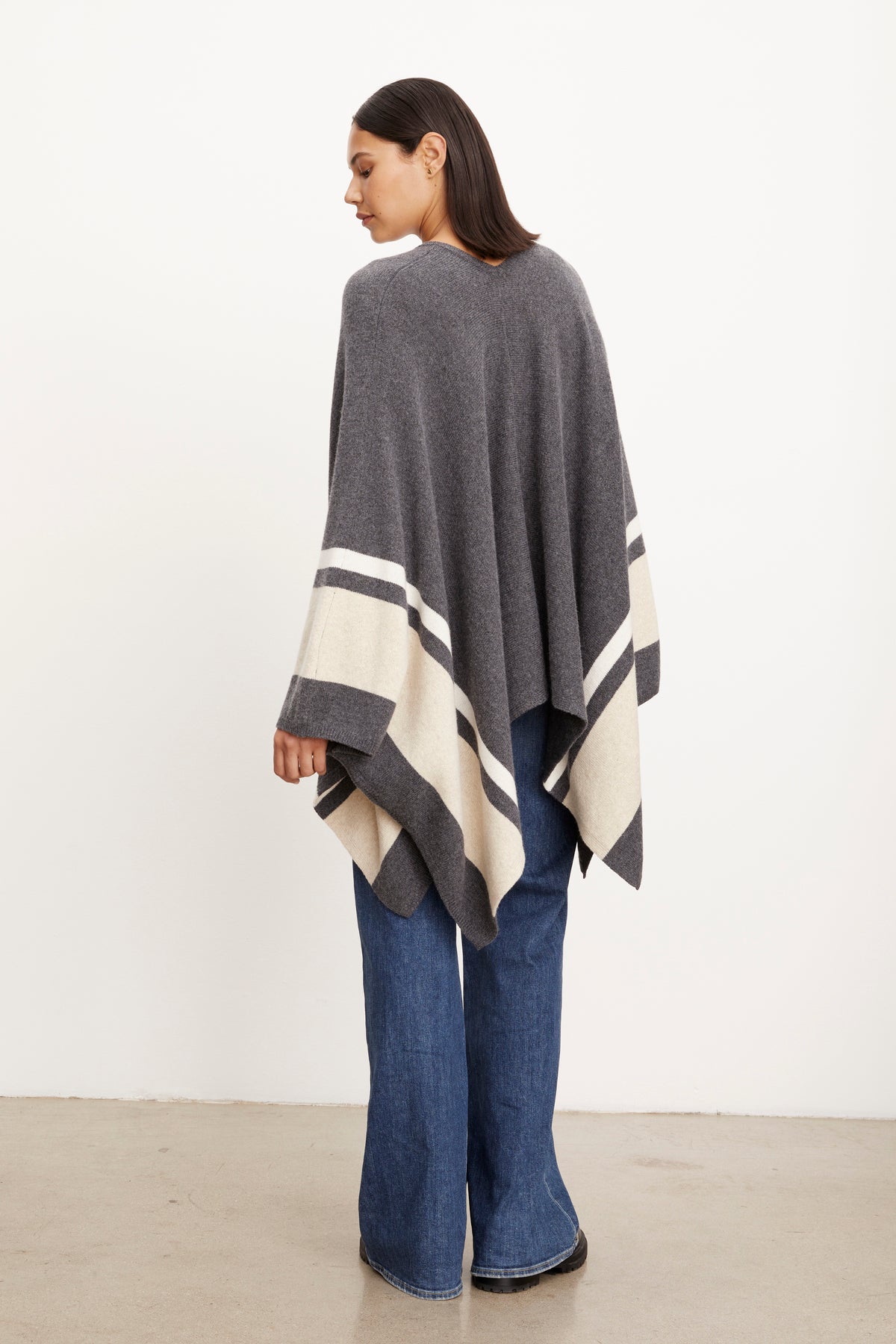 The back view of a woman wearing a Velvet by Graham & Spencer HARPER OPEN FRONT PONCHO.-26897793155265