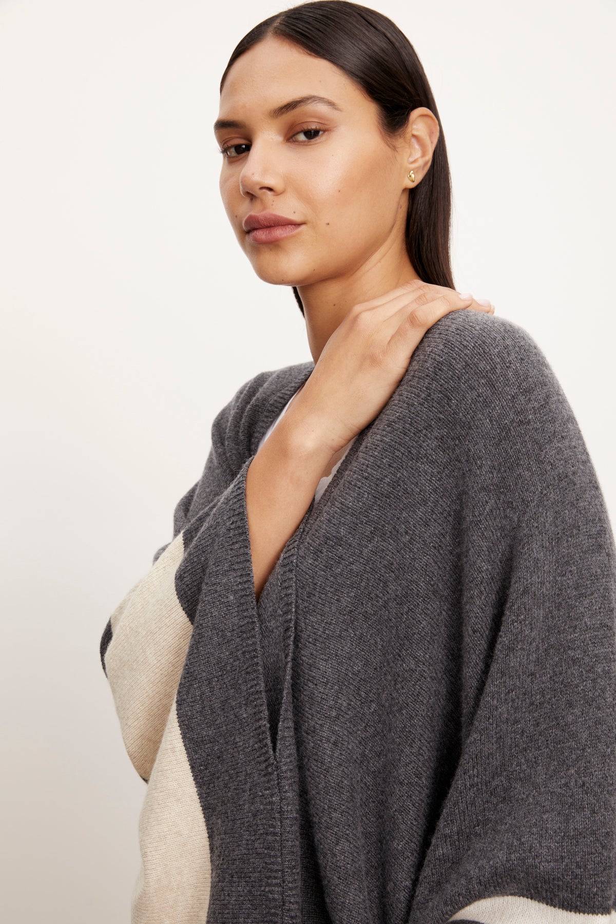 The model is wearing a Velvet by Graham & Spencer HARPER OPEN FRONT PONCHO in grey and beige.-26897793188033