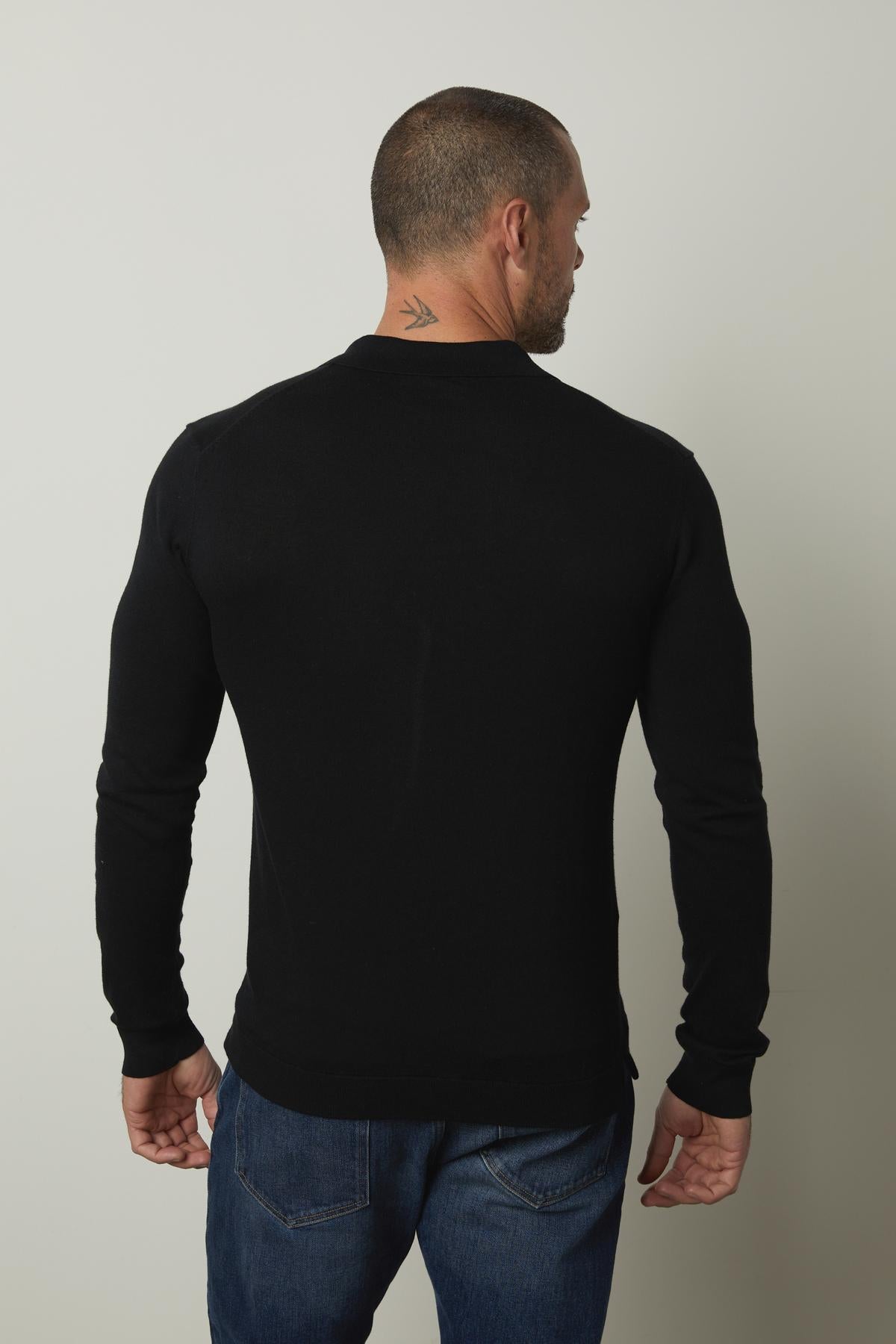  The back view of a man wearing a Velvet by Graham & Spencer GENO LINEN BLEND POLO sweater. 