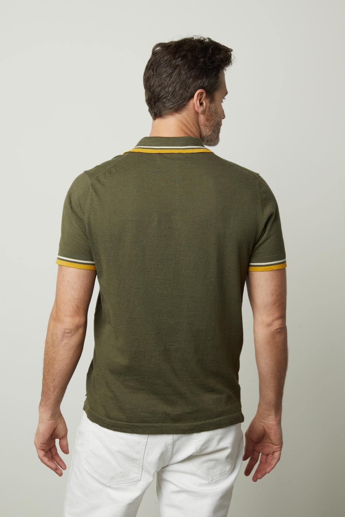   The back view of a man wearing a Velvet by Graham & Spencer GREGAN LINEN BLEND POLO. 