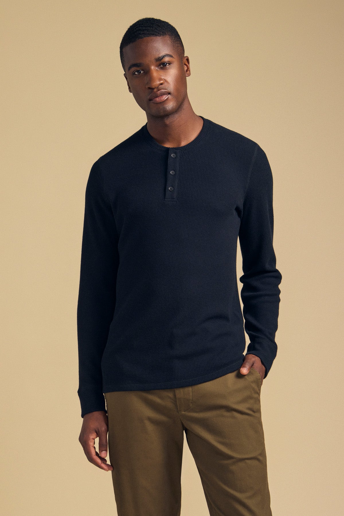 A man wearing a black Velvet by Graham & Spencer ROEN THERMAL HENLEY, a long-sleeved brushed shirt with a buttoned placket.-46288291070145