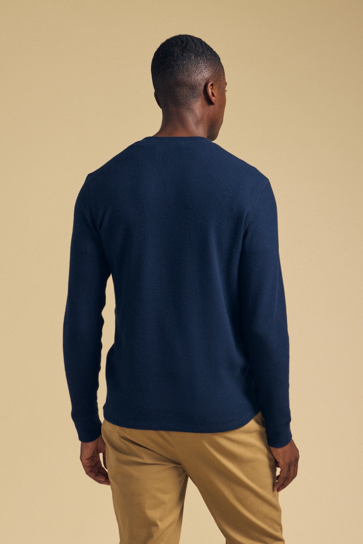 Back view of a person wearing a navy blue TOLLIVER THERMAL CREW PULLOVER and tan pants.-46288500621505