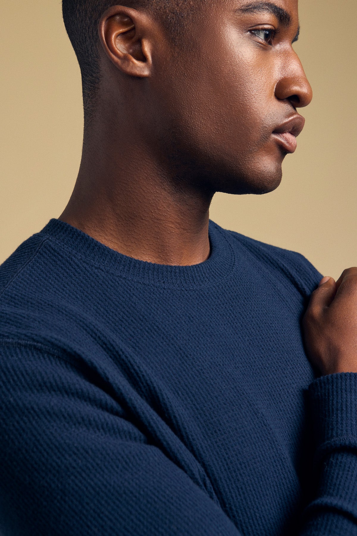 A man in profile wears a navy blue brushed TOLLIVER THERMAL CREW PULLOVER.