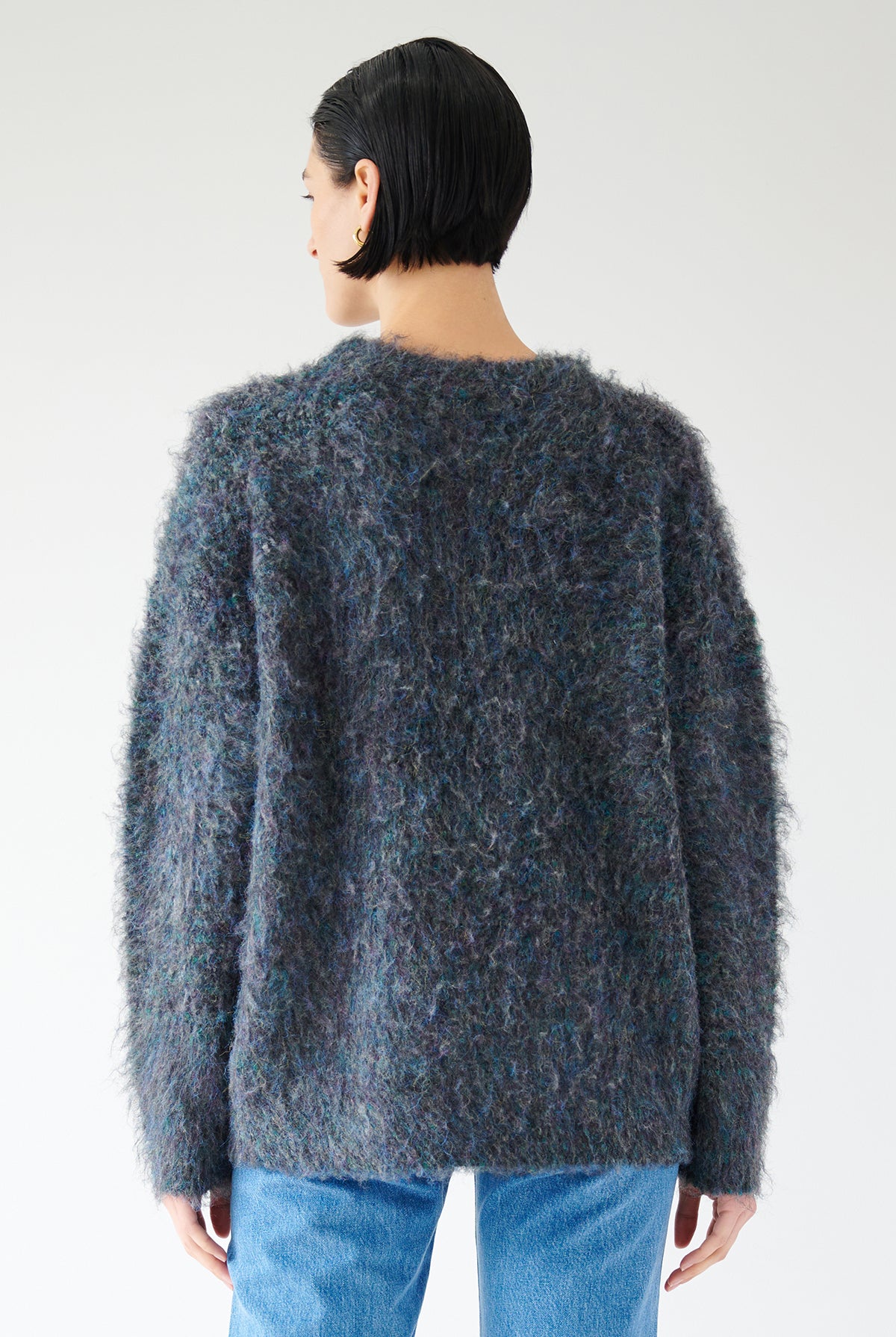 The back view of a woman wearing a Valencia sweater by Velvet by Jenny Graham in a vibrant blue, showcasing its versatility and stylish addition to any wardrobe.-35547899527361