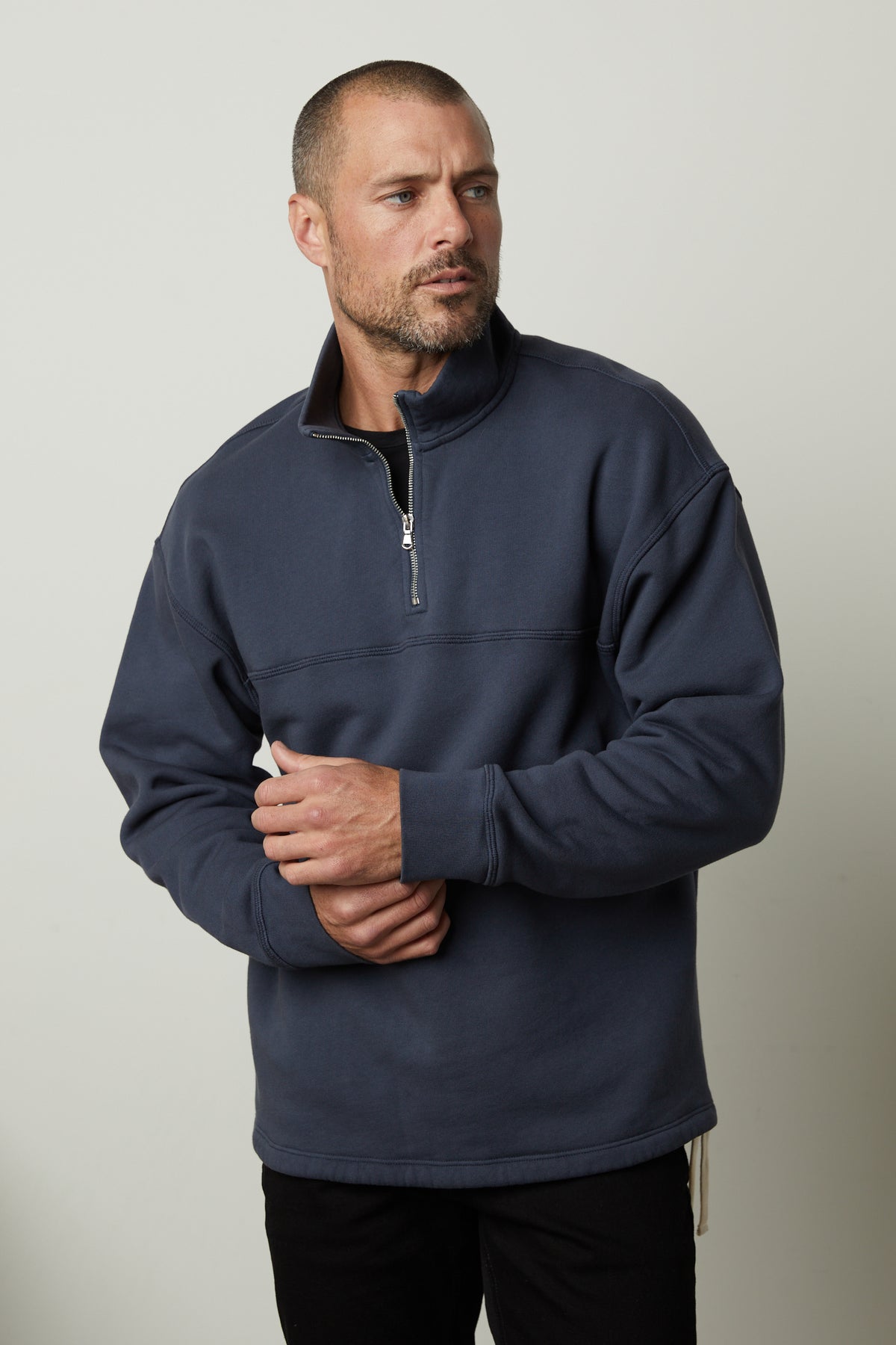 A man wearing a Velvet by Graham & Spencer Bosco quarter-zip sweatshirt in soft brushed fleece.-35782782615745