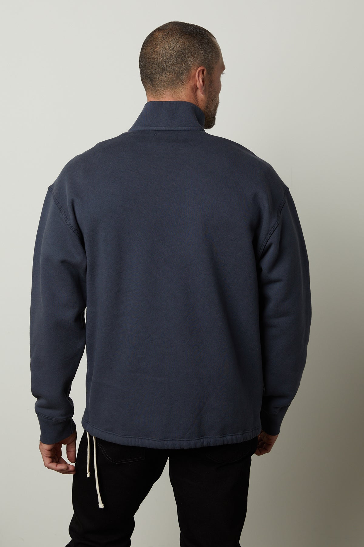   The back view of a man wearing a Velvet by Graham & Spencer BOSCO QUARTER-ZIP SWEATSHIRT. 