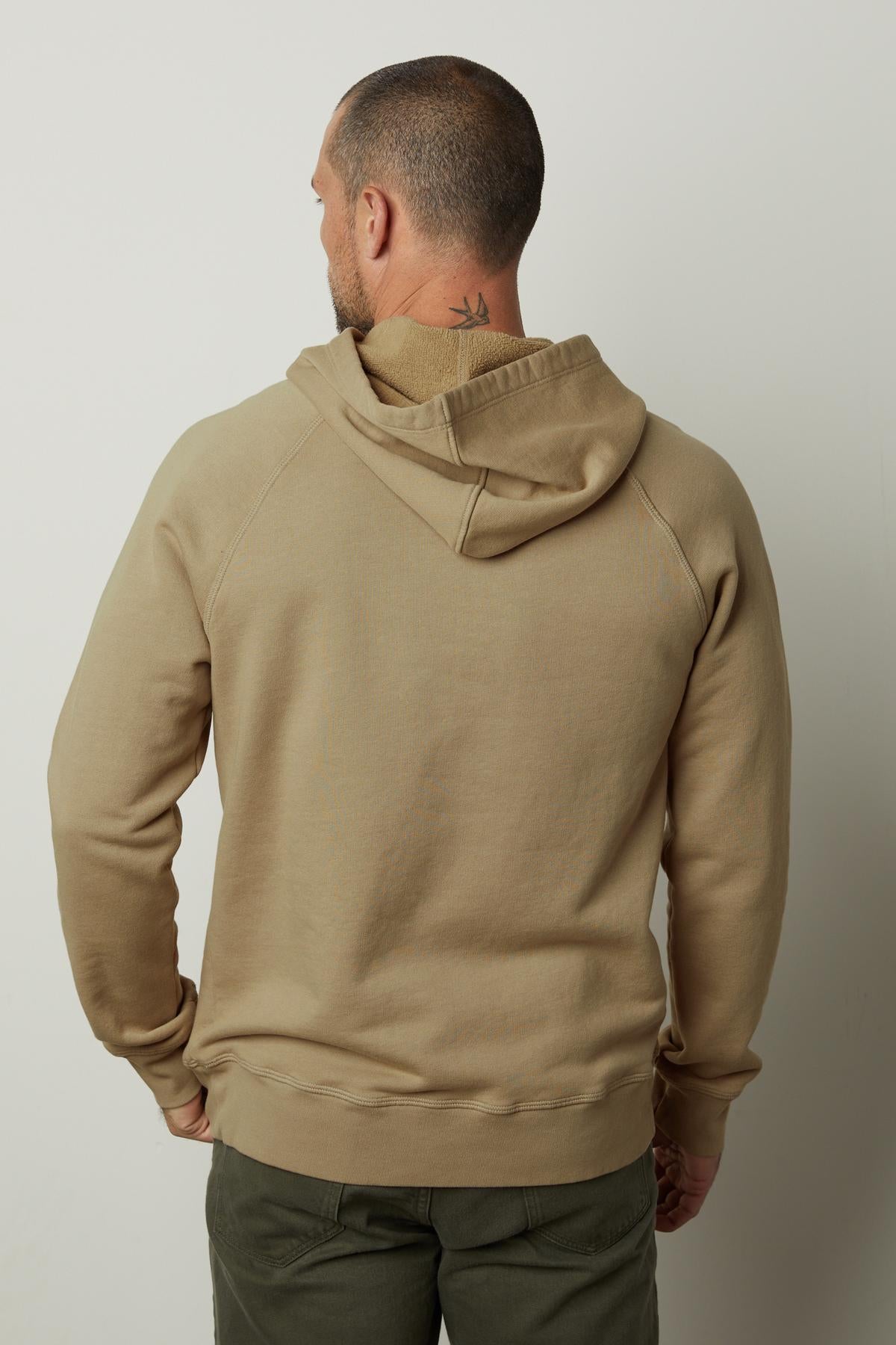 The back view of a man wearing a Velvet by Graham & Spencer HOPKIN PULLOVER HOODIE made with brushed fleece for comfort.-35547534065857