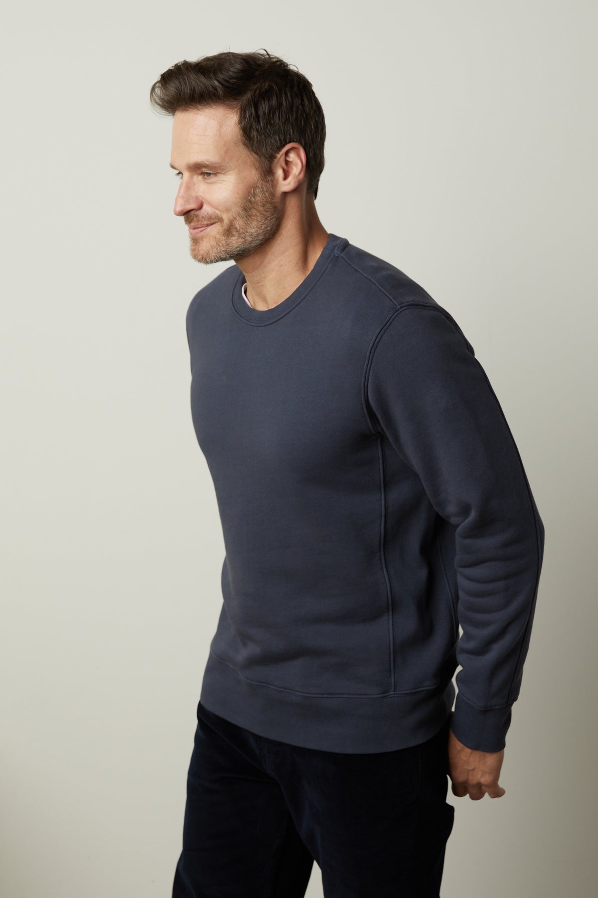   A man wearing a Velvet by Graham & Spencer KING CREW NECK SWEATSHIRT and pants. 