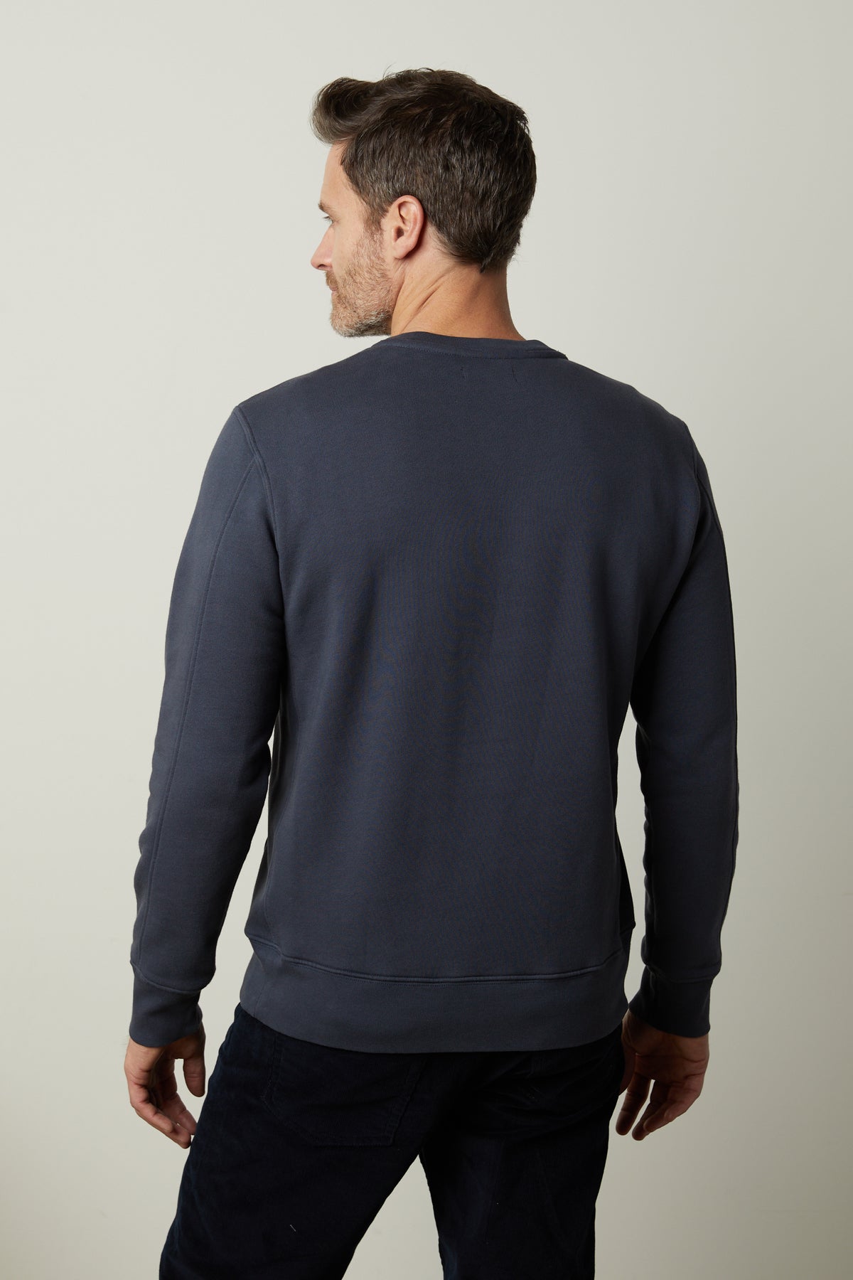   The back view of a man wearing a Velvet by Graham & Spencer KING CREW NECK SWEATSHIRT. 
