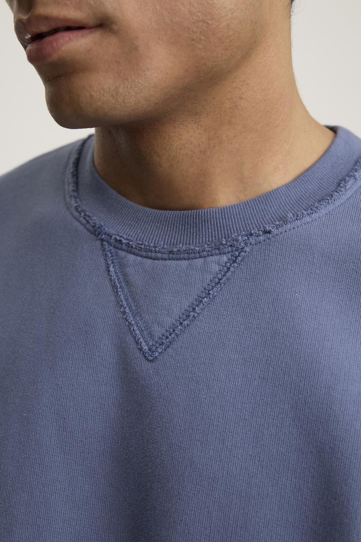   A person wearing the Forrest Sweatshirt by Velvet by Graham & Spencer appreciates its relaxed fit and ribbed trims, crafted from heavyweight cotton fleece, with visible stitching details around the collar. 