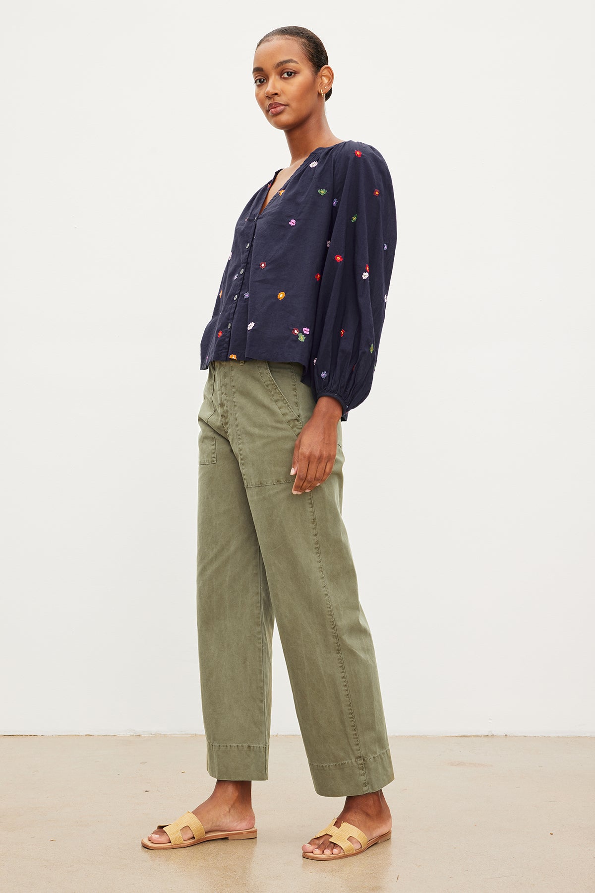 The model is wearing the Velvet by Graham & Spencer "ARETHA EMBROIDERED BOHO TOP" blouse and velvet pants.-35955411452097