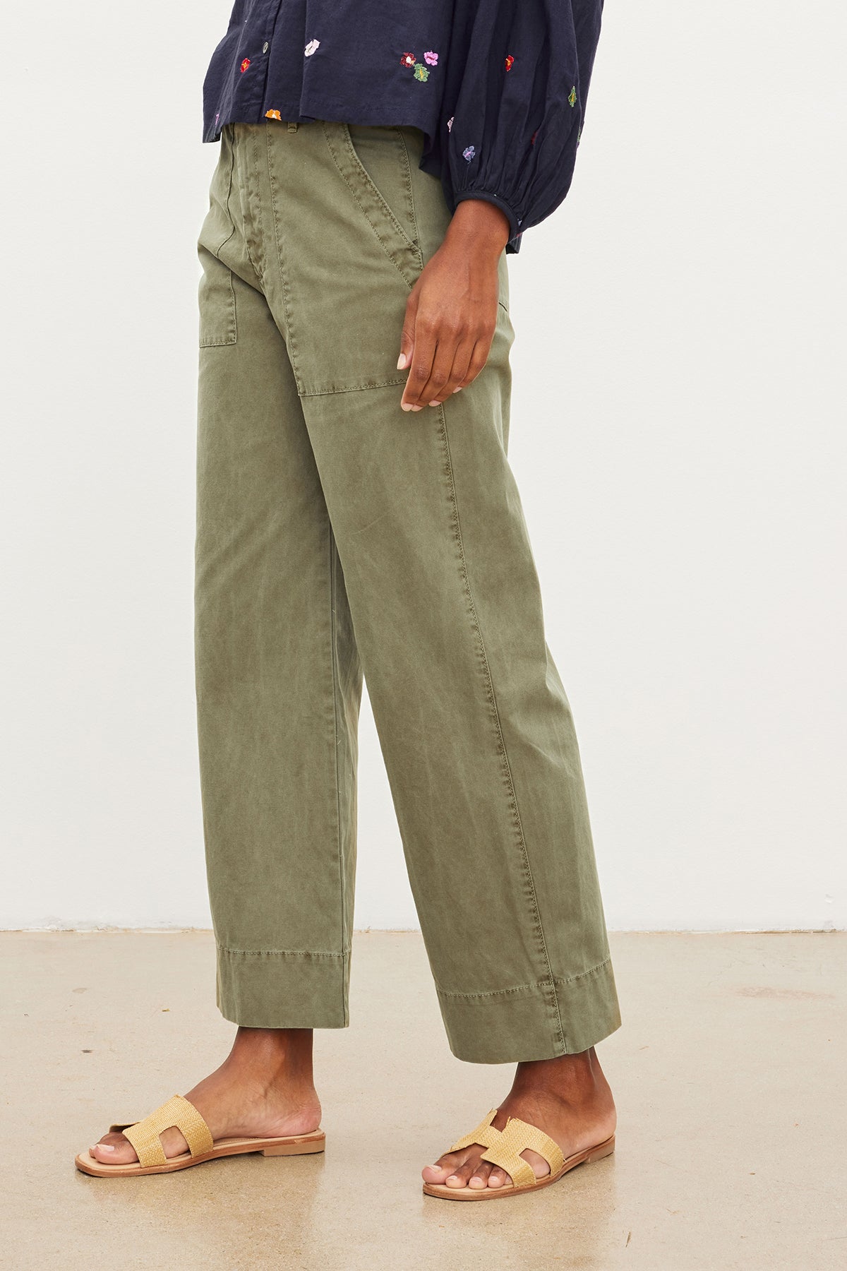   A woman wearing slim top and Velvet by Graham & Spencer green MYA COTTON CANVAS PANTS. 