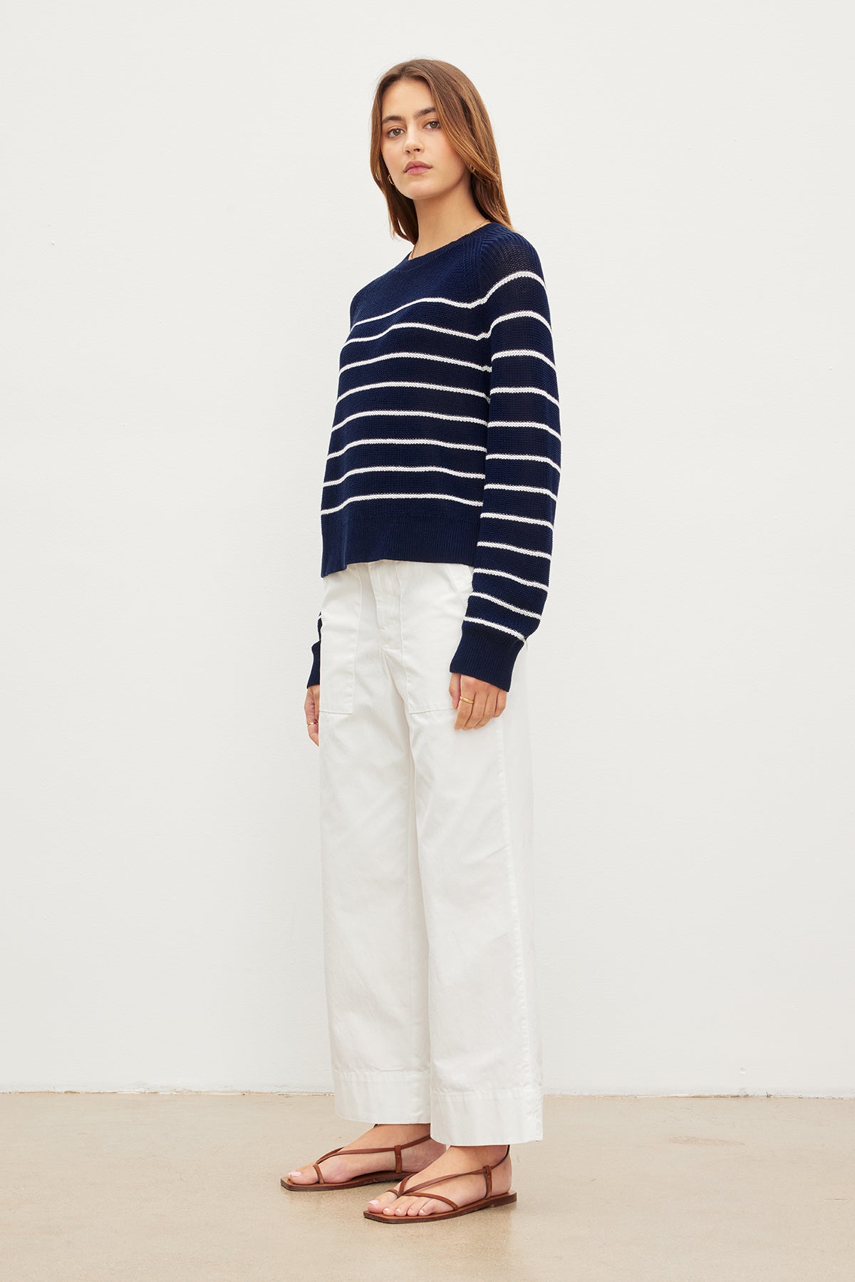 The model is wearing a CHAYSE STRIPED CREW NECK SWEATER by Velvet by Graham & Spencer with a relaxed silhouette and white wide leg pants.-35955537281217