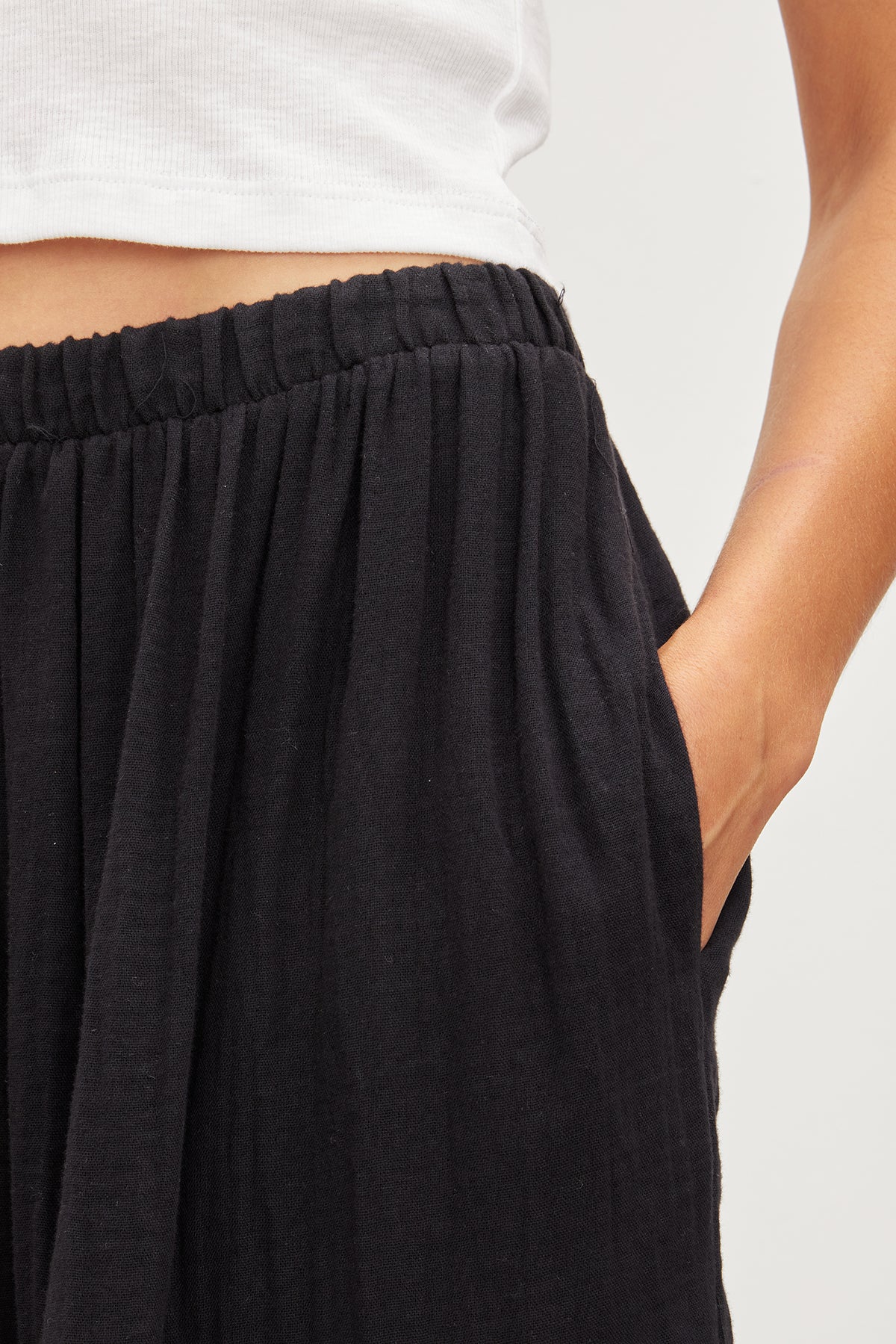   A woman wearing a Velvet by Graham & Spencer Danielle Cotton Gauze Tiered Skirt with an elastic waist. 