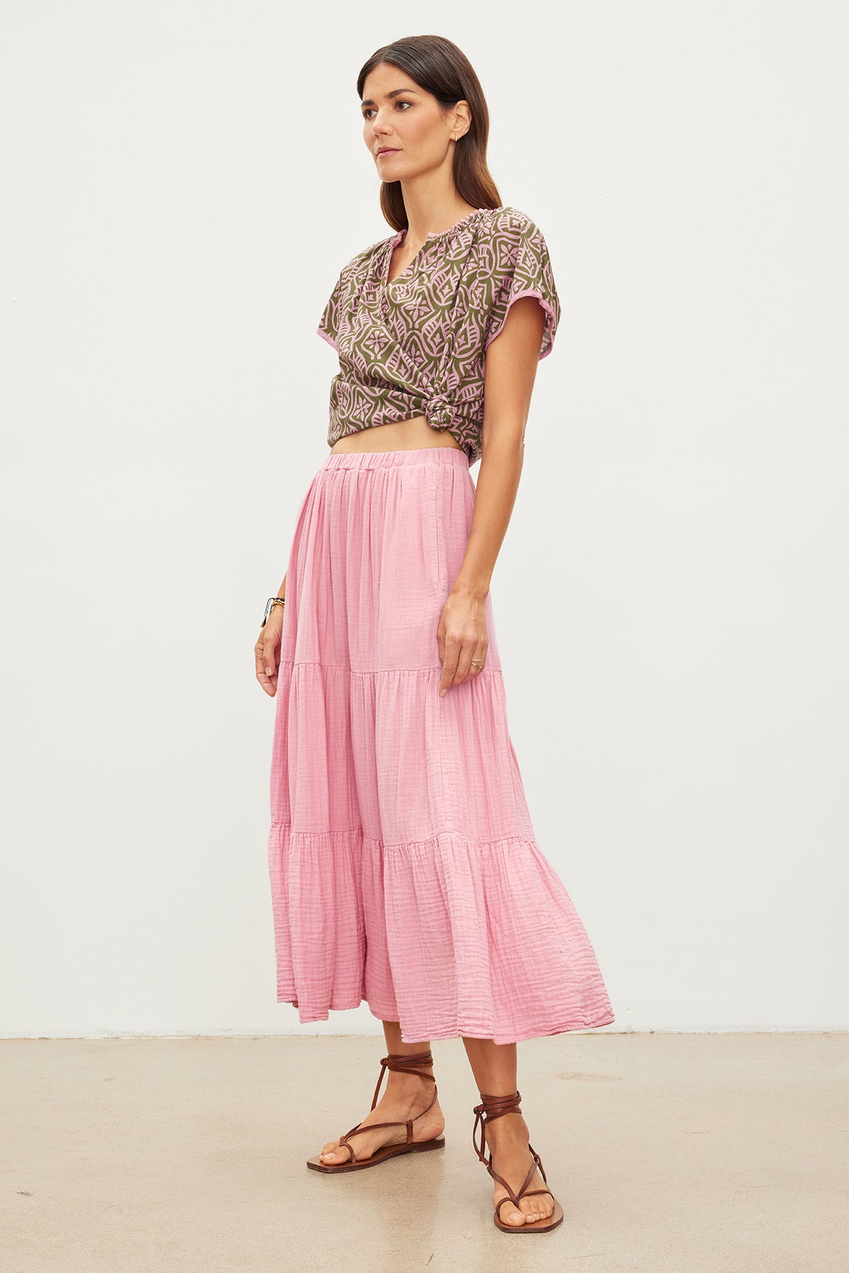 The model is wearing a Velvet by Graham & Spencer pink midi skirt with ruffle detail.-35967654363329