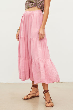 An essential woman's outfit featuring a pink ruffled DANIELLE COTTON GAUZE TIERED SKIRT made by Velvet by Graham & Spencer and paired with comfortable sandals.