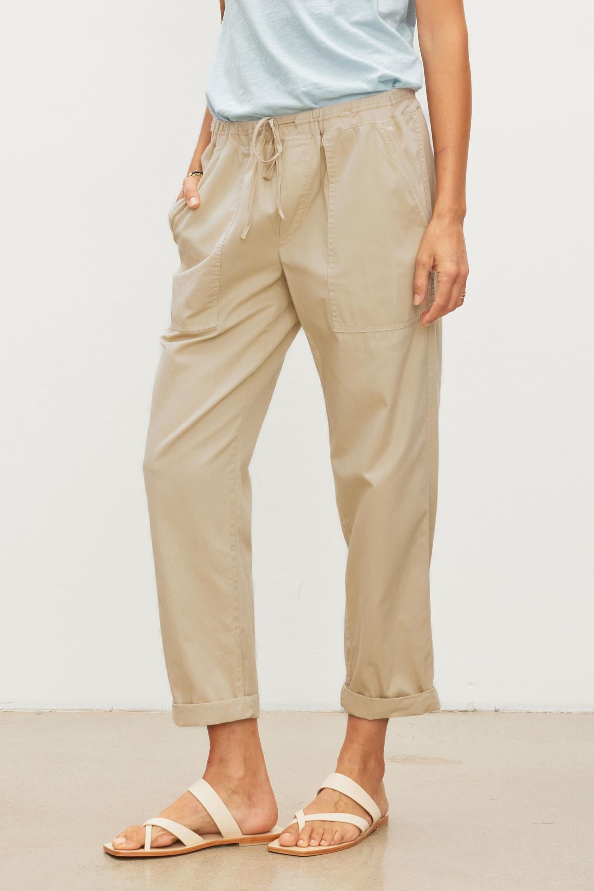   A woman wearing a tan shirt and Velvet by Graham & Spencer's MISTY COTTON TWILL PANT with an elastic waist. 