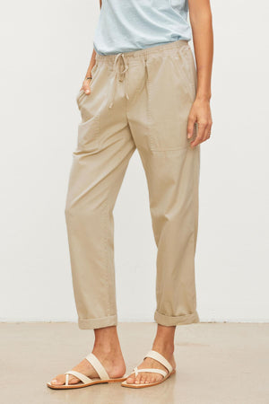 A woman wearing a tan shirt and Velvet by Graham & Spencer's MISTY COTTON TWILL PANT with an elastic waist.
