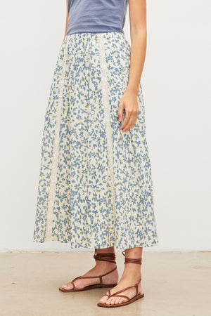 A woman wearing a KONA FLORAL LACE MAXI SKIRT from Velvet by Graham & Spencer with an elastic waist.