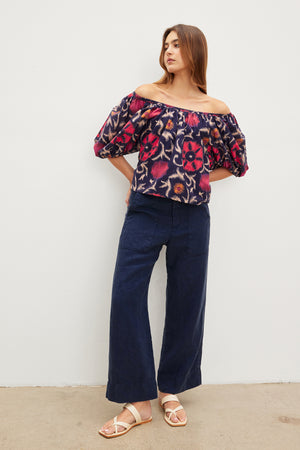 A woman wearing a Velvet by Graham & Spencer EDLIN PRINTED SILK COTTON VOILE top and wide leg pants.