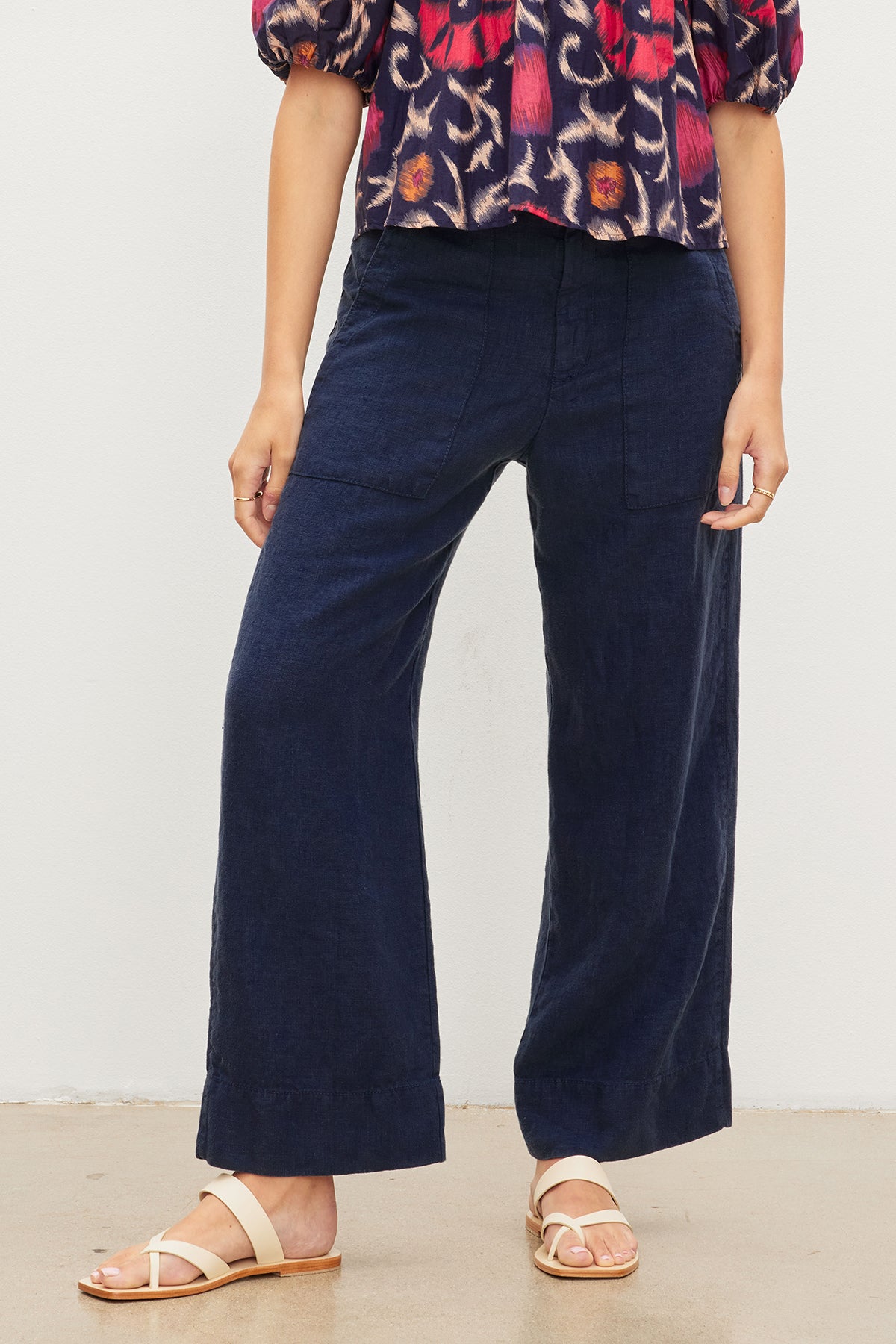 A stylish woman wearing a cool floral top and Velvet by Graham & Spencer DRU HEAVY LINEN PANT wide leg pants.-35982296088769