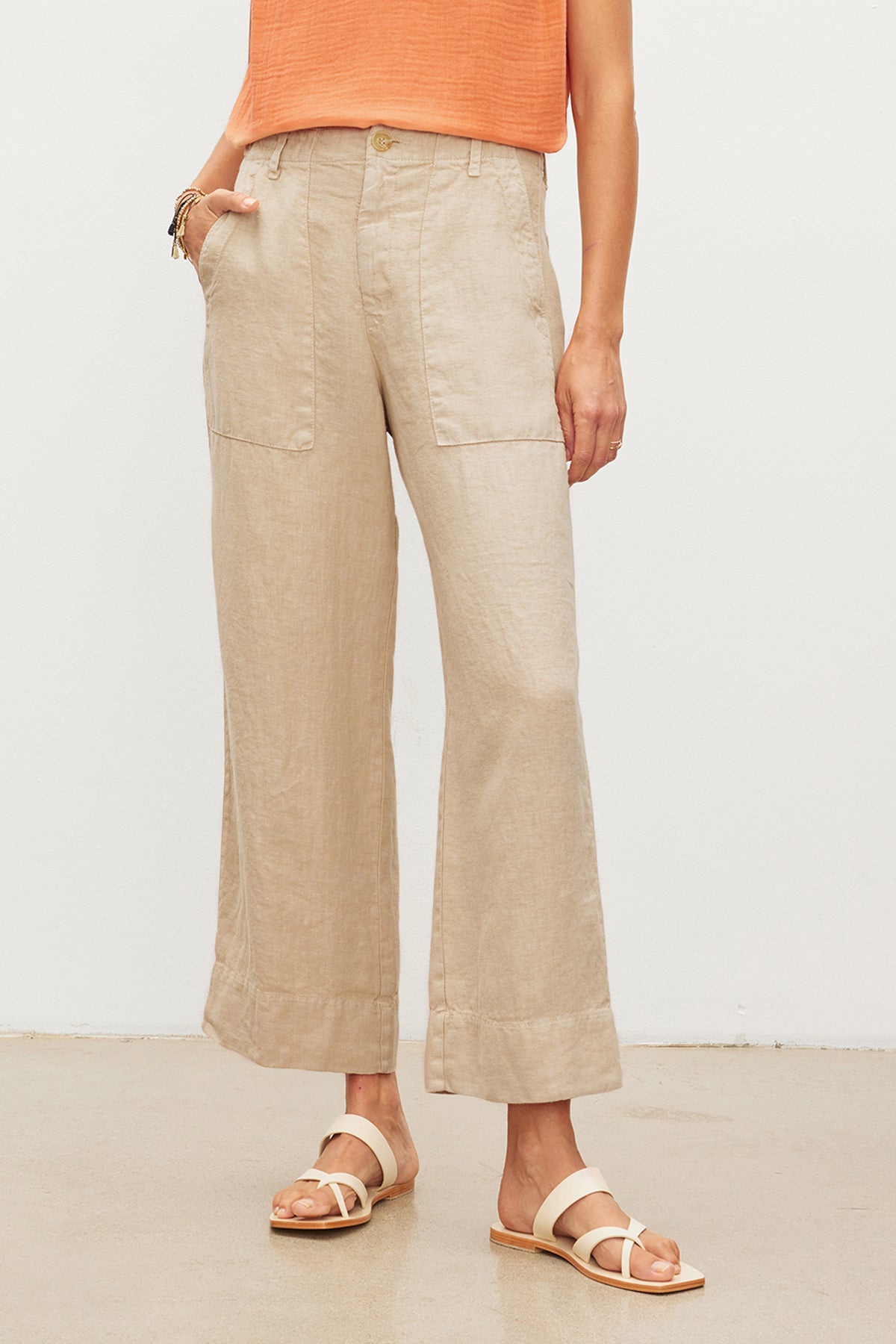   Woman wearing Velvet by Graham & Spencer DRU Heavy Linen Pant with patch pockets and strappy sandals. 