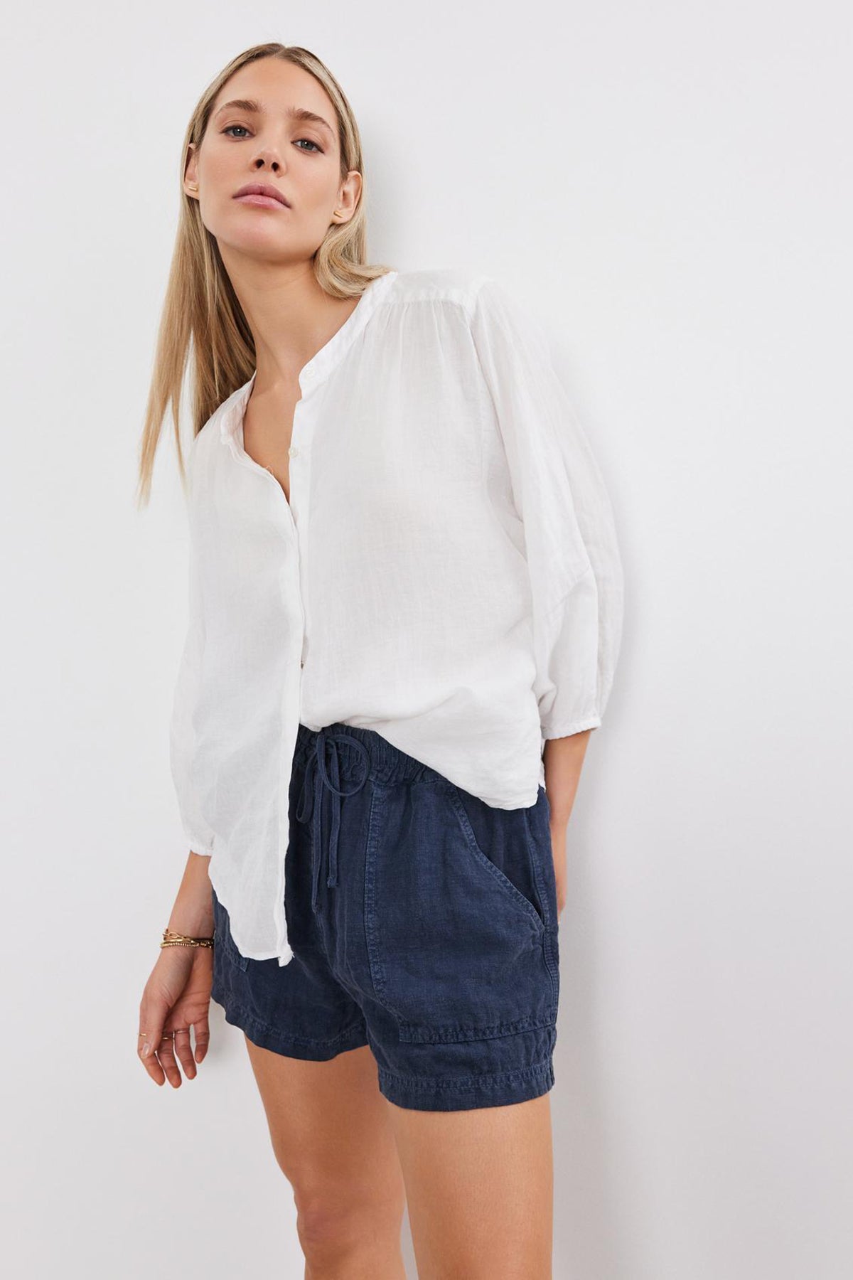   Woman in a white blouse and Velvet by Graham & Spencer's SUTTON HEAVY LINEN SHORT standing against a plain background. 