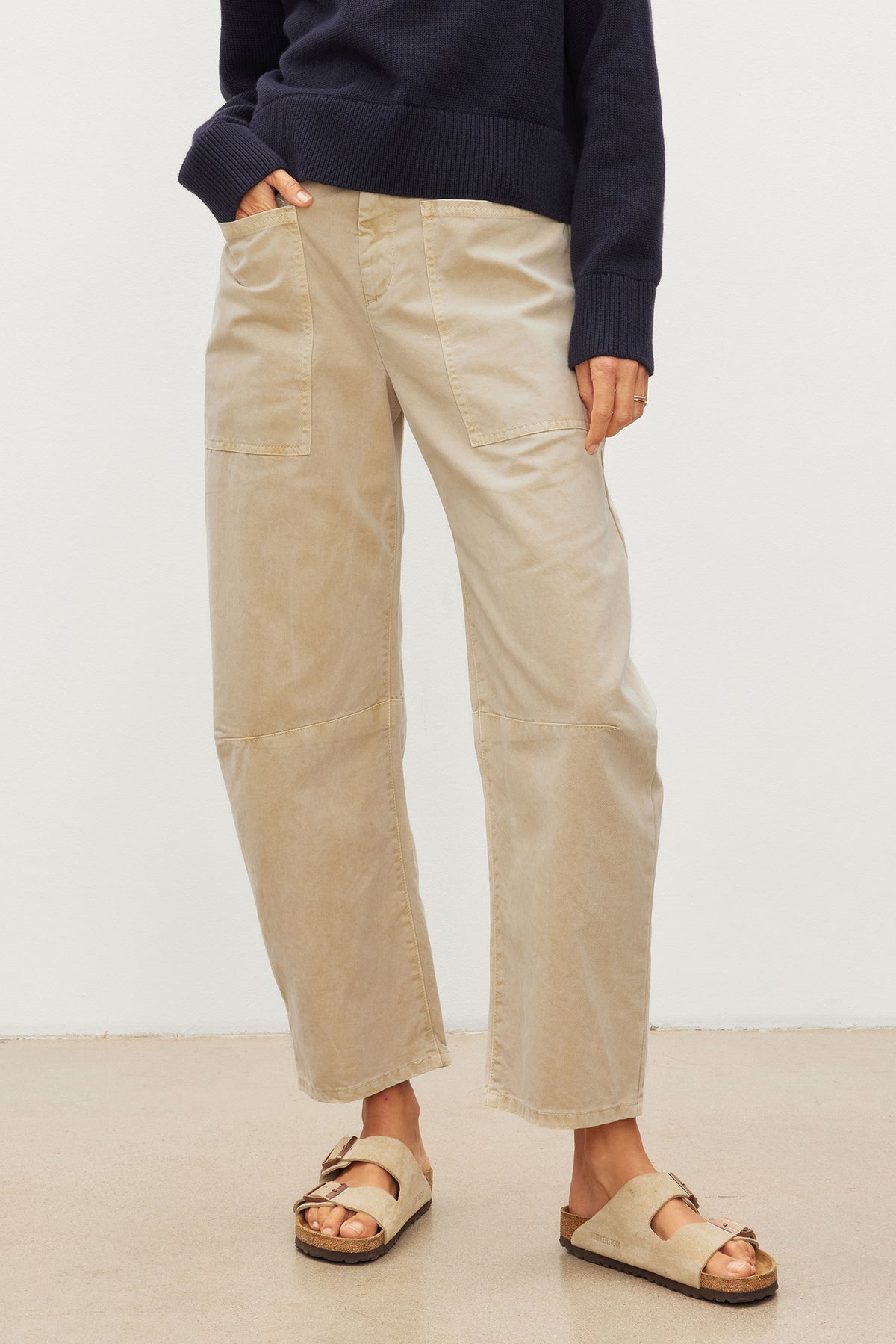   The model is wearing beige BRYLIE SANDED TWILL UTILITY PANT made by Velvet by Graham & Spencer. 