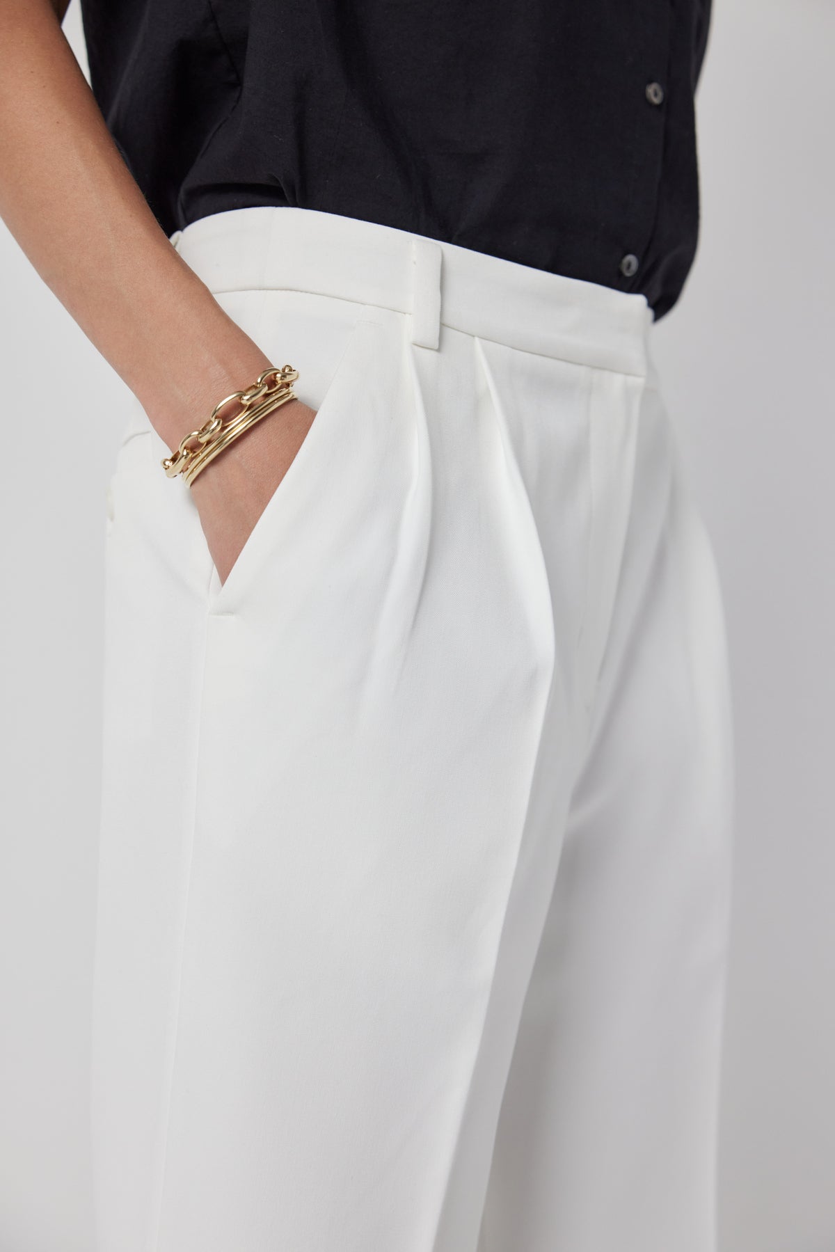 A woman wearing Velvet by Jenny Graham's BUNDY PANT trousers and a gold bracelet.-36168659173569