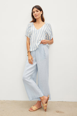 The model is wearing a lightweight linen woven striped top and Velvet by Graham & Spencer wide leg pants.