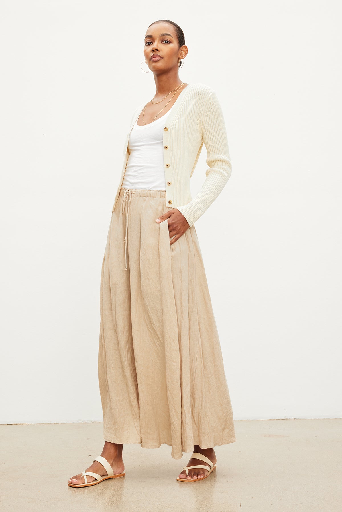 The model is wearing a Velvet by Graham & Spencer BAILEY LINEN MAXI SKIRT with an elastic drawstring waist.-35955424100545