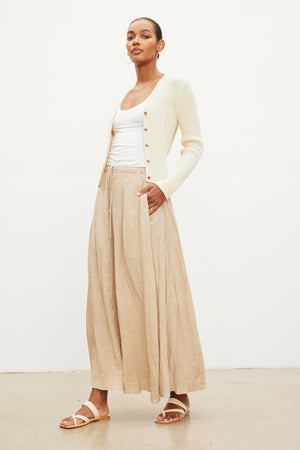 The model is wearing a Velvet by Graham & Spencer BAILEY LINEN MAXI SKIRT with an elastic drawstring waist.
