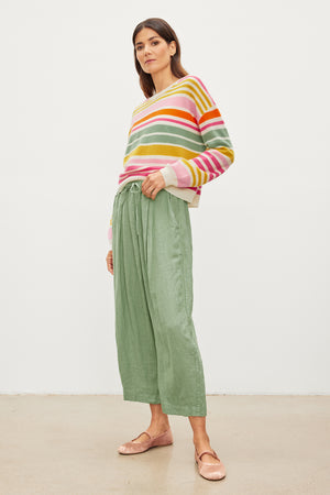 The model is wearing a Velvet by Graham & Spencer Hannah Linen Wide Leg Pant, featuring double pleats.