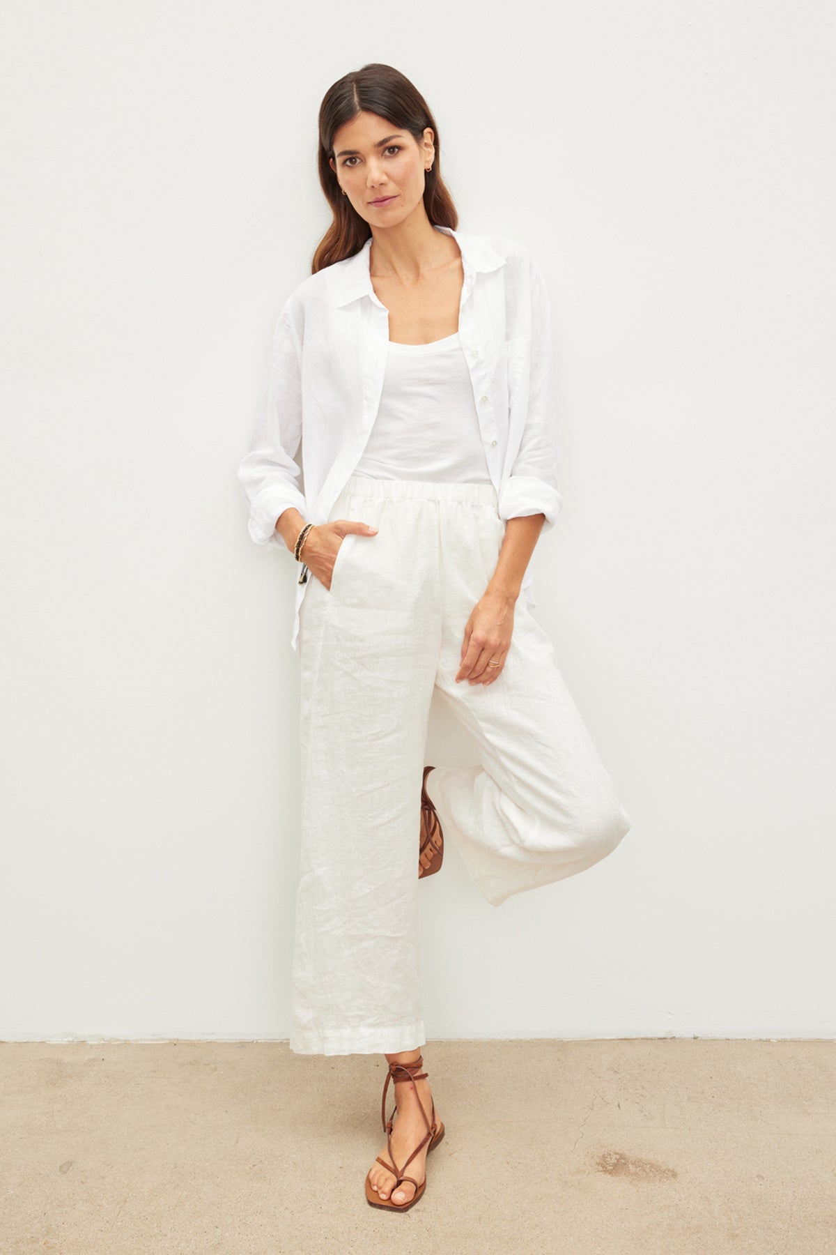 A woman wearing LOLA LINEN PANT by Velvet by Graham & Spencer lightweight linen pants with an elastic waist and a white shirt.-36002707931329