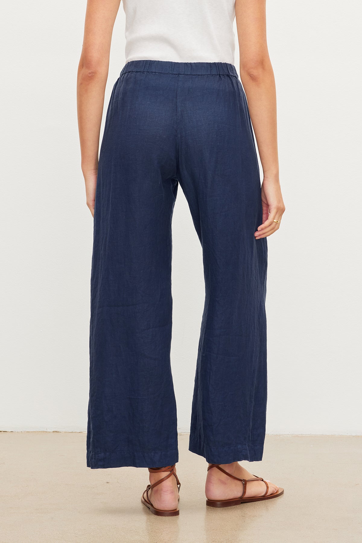 The back view of a woman wearing Velvet by Graham & Spencer's LOLA LINEN PANT.-36161318650049