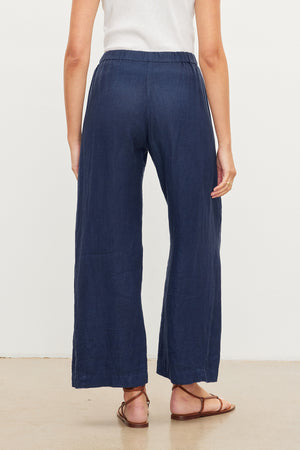 The back view of a woman wearing Velvet by Graham & Spencer's LOLA LINEN PANT.