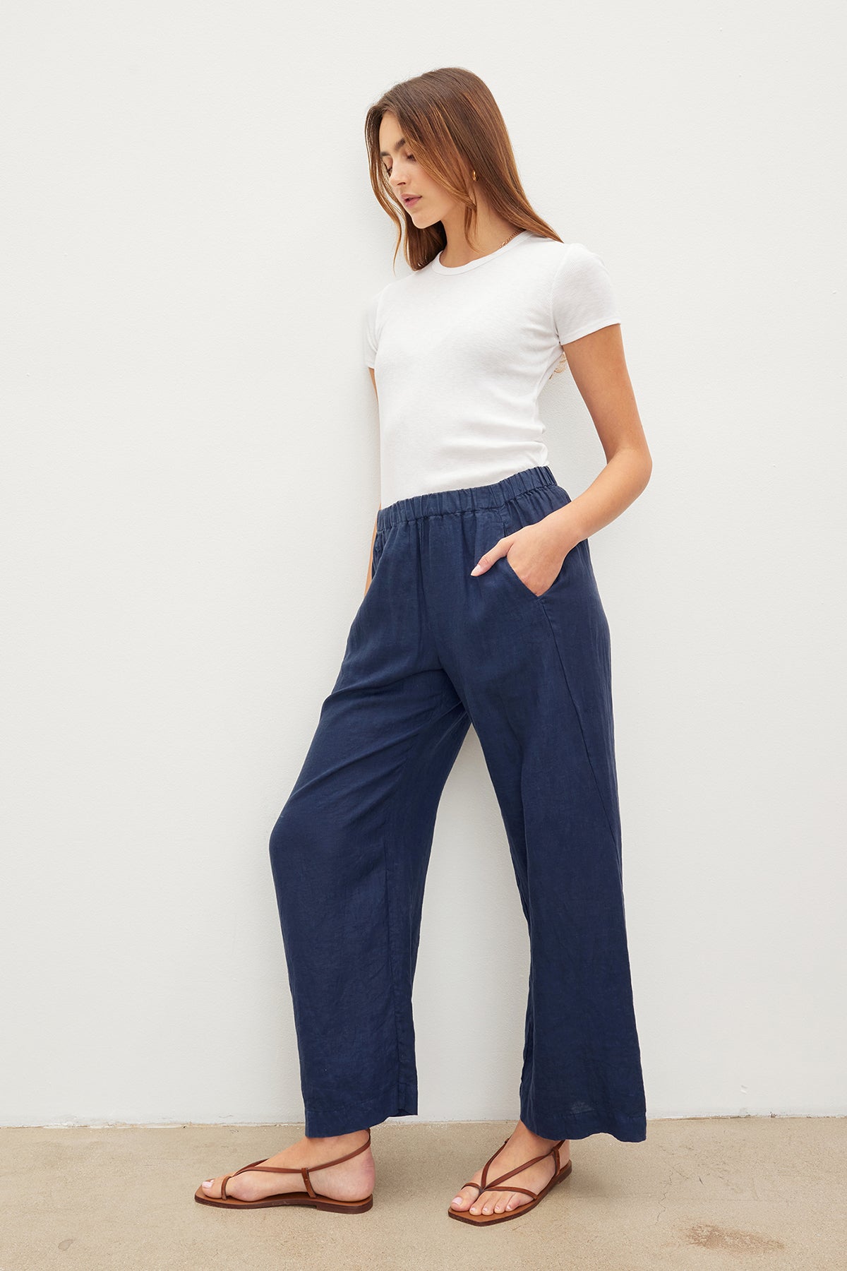   A woman wearing Velvet by Graham & Spencer LOLA LINEN PANT with an elastic waist. 