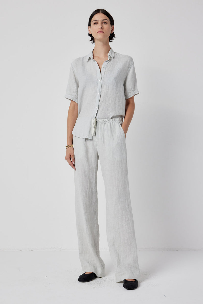 The model is wearing a white linen pant and a MULHOLLAND SHIRT by Velvet by Jenny Graham.