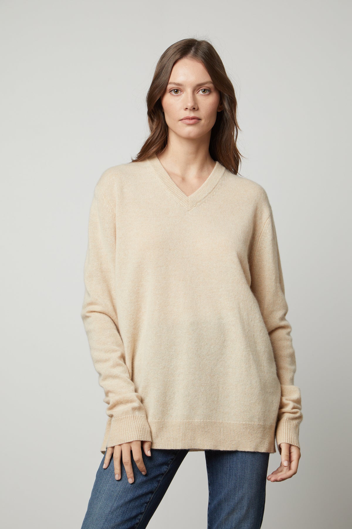   The Velvet by Graham & Spencer oversized cashmere v-neck sweater in beige. 