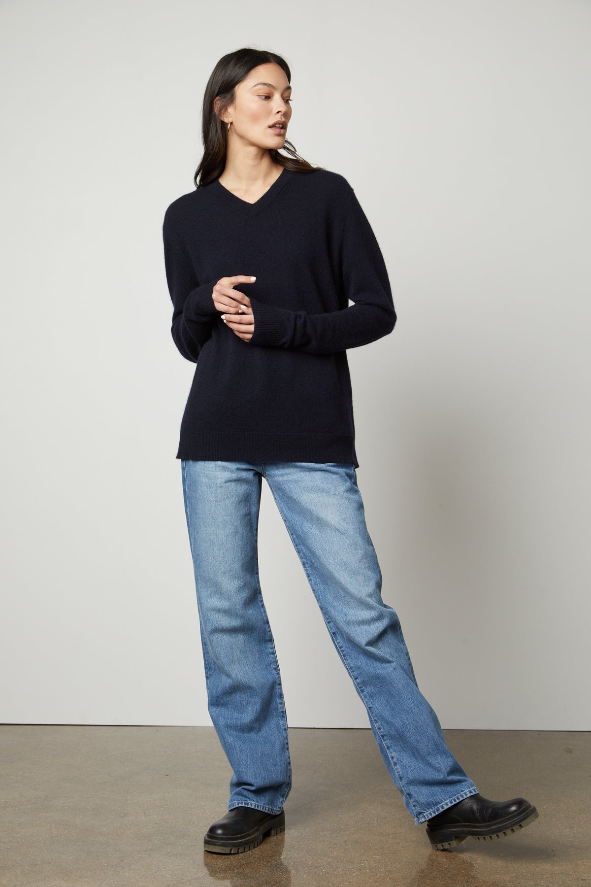   The model is wearing jeans and a Velvet by Graham & Spencer Harmony Cashmere V-Neck Sweater. 