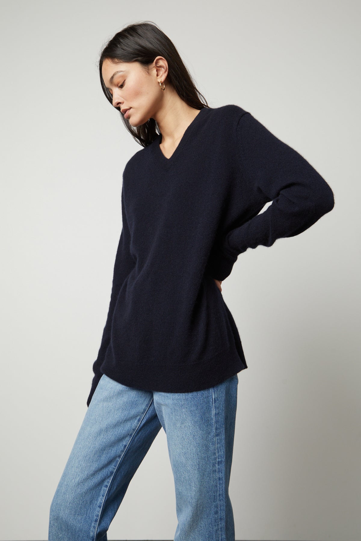 The model is wearing jeans and a Velvet by Graham & Spencer Harmony Cashmere V-Neck Sweater.-26897789681857