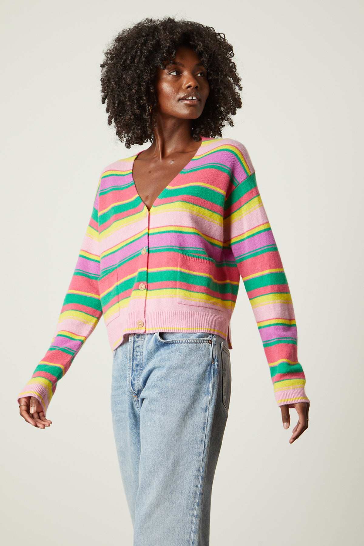 A model wearing a Velvet by Graham & Spencer JANESSA CASHMERE STRIPED CARDIGAN, a vintage-inspired, colorful striped cardigan.-26496305168577