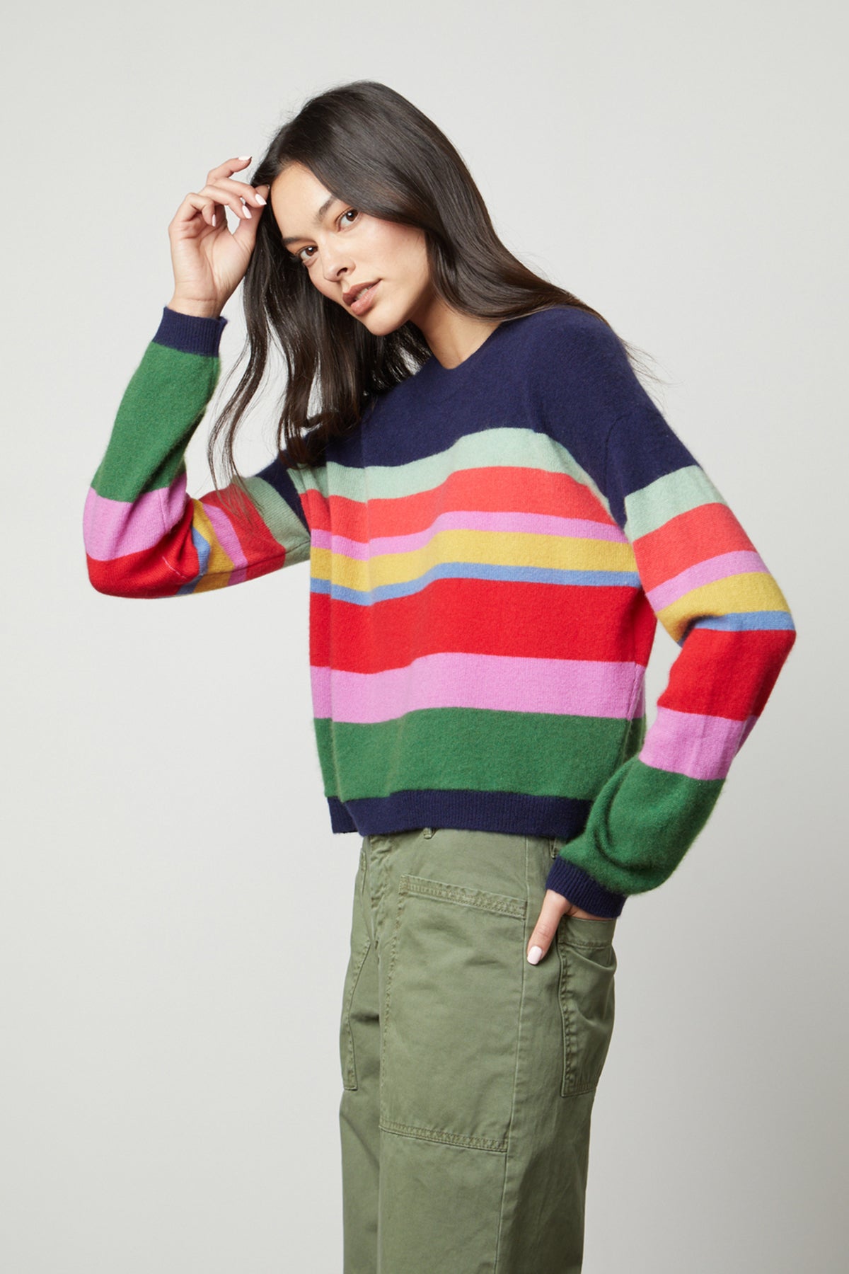 A model wearing a KACEY CASHMERE STRIPED CREW NECK sweater by Velvet by Graham & Spencer and green pants.-26897828610241