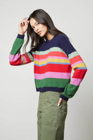 A model wearing a KACEY CASHMERE STRIPED CREW NECK sweater by Velvet by Graham & Spencer and green pants.