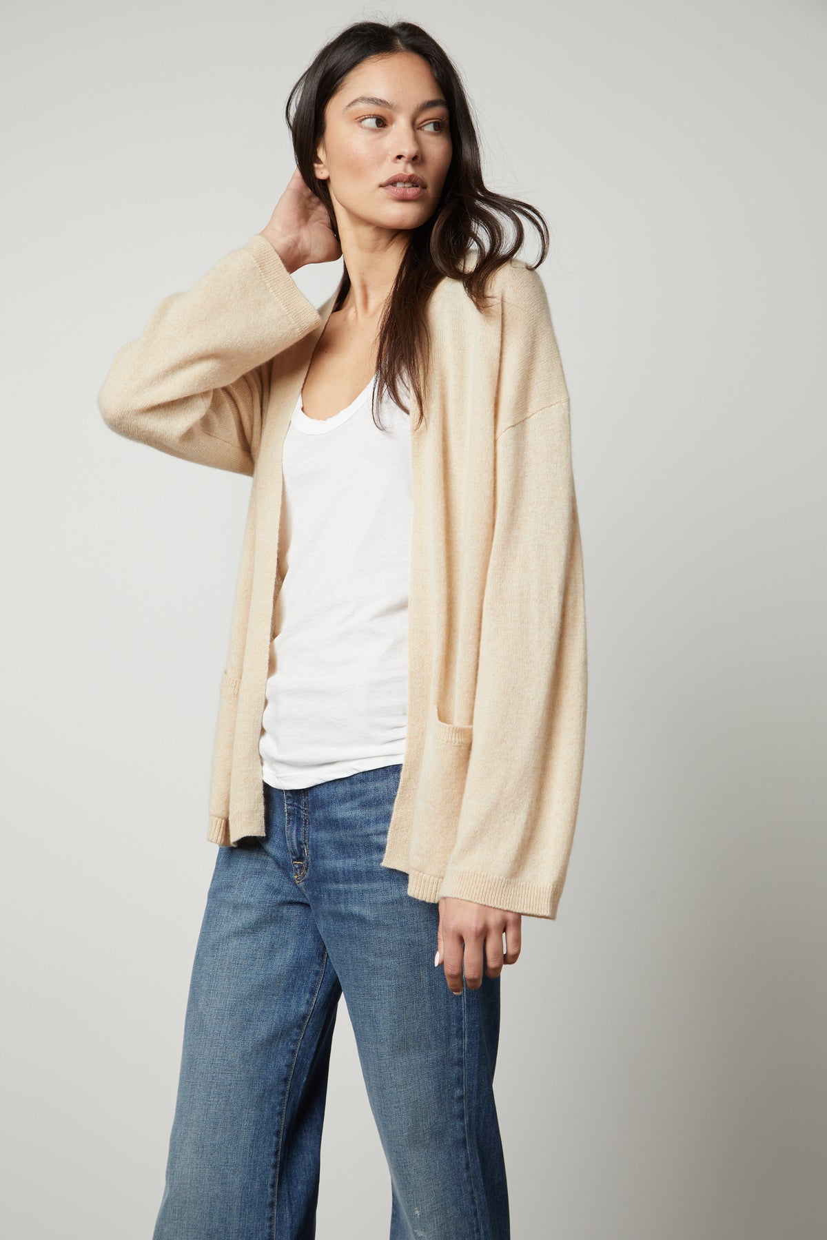 The model is wearing jeans and a Velvet by Graham & Spencer LILA CASHMERE CARDIGAN.-26910345789633