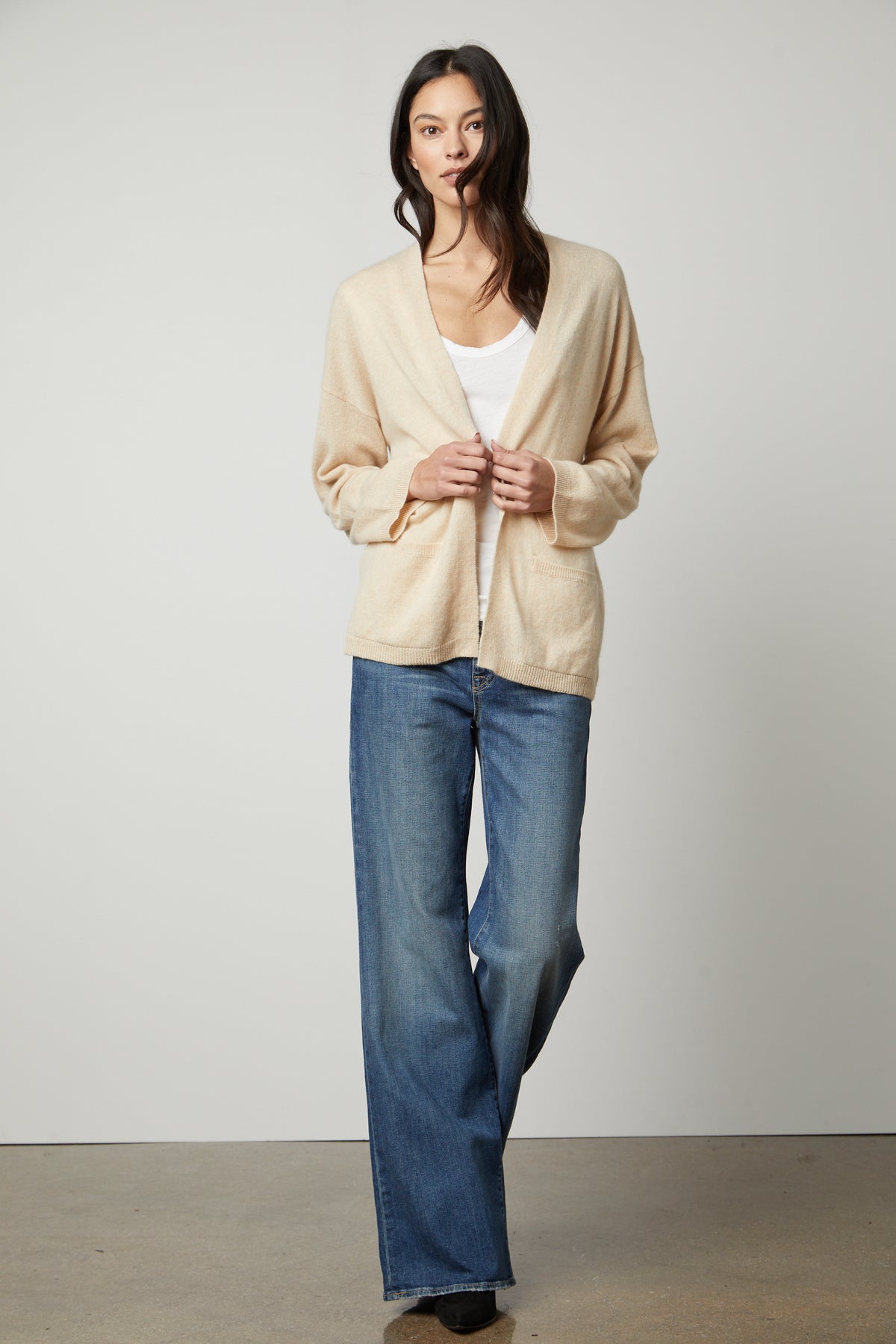 The model is wearing a LILA CASHMERE CARDIGAN by Velvet by Graham & Spencer and wide leg jeans.-26910345822401