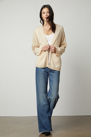 The model is wearing a LILA CASHMERE CARDIGAN by Velvet by Graham & Spencer and wide leg jeans.