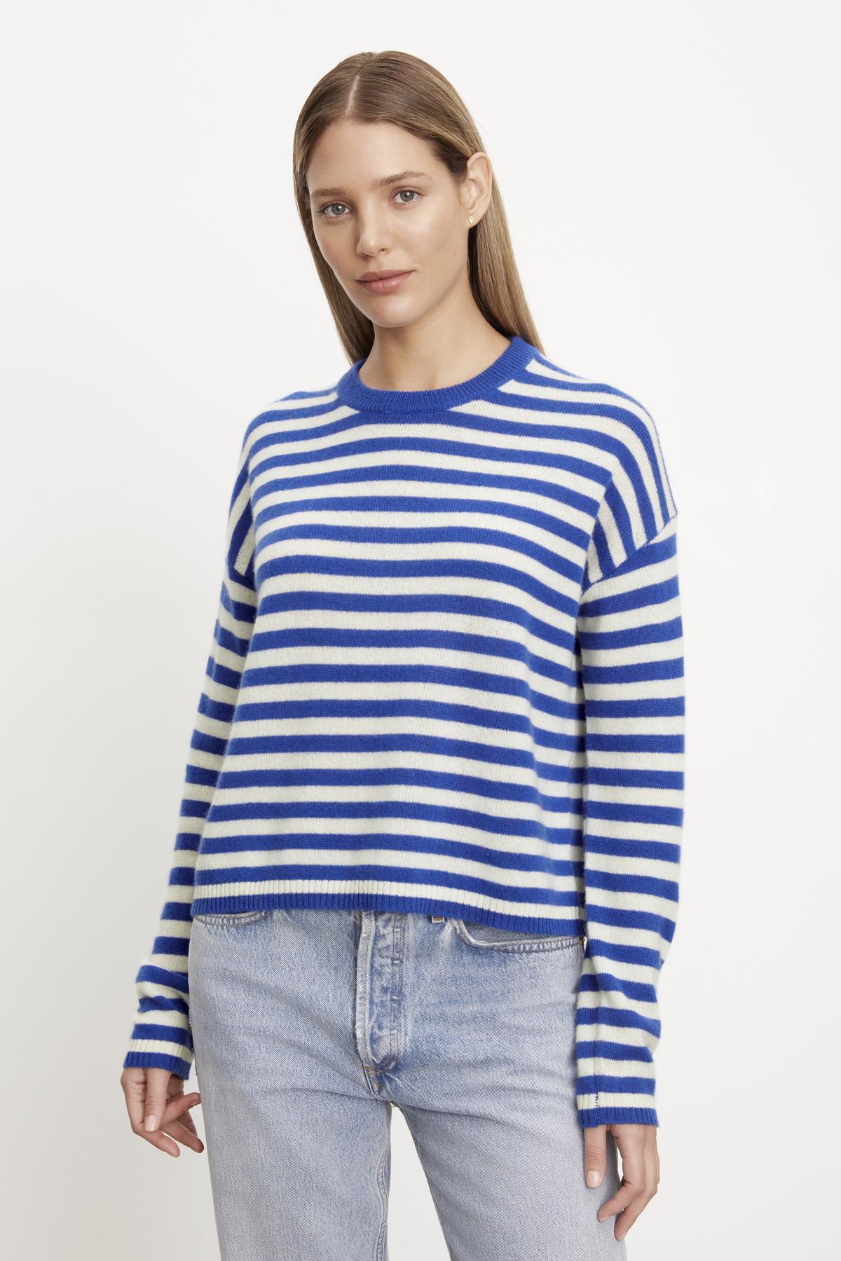   The model is wearing the ALYSSA CASHMERE STRIPED CREW NECK SWEATER from Velvet by Graham & Spencer. 